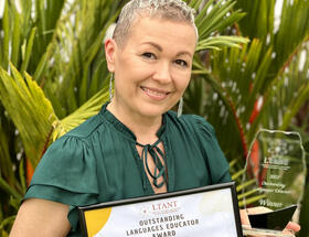 Olga holding her award.